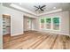 Spacious primary bedroom featuring tray ceilings, wood floors, and multiple windows with outdoor views at 240 Mark Ryan Ln, Dallas, NC 28034