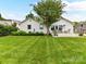 Manicured lawn extends to a deck with an outdoor seating area in the backyard at 2636 Chilton Pl, Charlotte, NC 28207