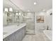 Bathroom featuring a large vanity with double sinks, glass enclosed shower, and modern lighting at 2636 Chilton Pl, Charlotte, NC 28207