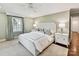 Bright bedroom featuring a comfortable bed, ceiling fan, and a soft color palette at 2636 Chilton Pl, Charlotte, NC 28207