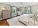 Bright bedroom with two windows, crown moulding, and hardwood floors at 2636 Chilton Pl, Charlotte, NC 28207