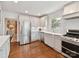 Kitchen featuring white cabinets, stainless steel appliances, and hardwood floors at 2636 Chilton Pl, Charlotte, NC 28207