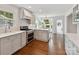 Open kitchen with large island, stainless appliances, and hardwood floors at 2636 Chilton Pl, Charlotte, NC 28207