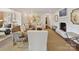 Bright living room features a fireplace, neutral colors, and lots of natural light from several windows and an open doorway at 2636 Chilton Pl, Charlotte, NC 28207