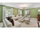 Bright living room features hardwood floors, a chandelier, and plush furniture at 2636 Chilton Pl, Charlotte, NC 28207