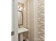 Charming powder room featuring a pedestal sink and decorative wallpaper at 2636 Chilton Pl, Charlotte, NC 28207