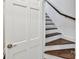 Hallway with door and dark hardwood stairs with a white risers at 2636 Chilton Pl, Charlotte, NC 28207