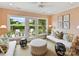 Relaxing sunroom with comfortable seating and views of the landscaped backyard through large windows and glass doors at 2636 Chilton Pl, Charlotte, NC 28207