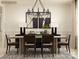 Dining room with seating for six, complemented by modern lamps and wainscoting at 2837 Morning Song Way, Lancaster, SC 29720