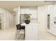 A bright, modern kitchen features white cabinets, stainless steel appliances, and a center island with breakfast bar at 2837 Morning Song Way, Lancaster, SC 29720