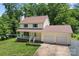Lovely home with a two-car garage and manicured lawn nestled among mature trees at 308 Home Rd, Salisbury, NC 28147