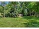 Expansive backyard featuring mature trees and a storage shed at 308 Home Rd, Salisbury, NC 28147