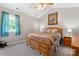 Inviting bedroom featuring a wooden bed frame, cozy carpeting, and bright windows at 308 Home Rd, Salisbury, NC 28147