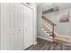 Hallway with wooden floors, stairs with carpet runner and white door with silver knobs at 308 Home Rd, Salisbury, NC 28147