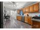 Spacious kitchen with stainless steel appliances, wood cabinets, and durable gray flooring at 308 Home Rd, Salisbury, NC 28147