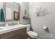 Stylish powder room with modern vanity, decorative mirror, and fresh neutral paint at 308 Home Rd, Salisbury, NC 28147