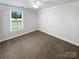 Cozy bedroom with neutral carpet, window, white walls, and base molding at 3090 Bridgewater St, Lancaster, SC 29720