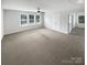 Large bedroom with neutral carpet, white walls, multiple windows, and a ceiling fan at 3090 Bridgewater St, Lancaster, SC 29720