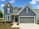 Charming two-story home with blue siding, stone accents, and a two-car garage at 3090 Bridgewater St, Lancaster, SC 29720
