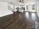 Open-concept living area showcasing hardwood floors, natural light, and open staircase at 3090 Bridgewater St, Lancaster, SC 29720