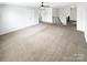 Spacious living room featuring neutral carpet, a ceiling fan, and staircase at 3090 Bridgewater St, Lancaster, SC 29720