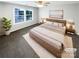 A serene main bedroom with a large window and minimalist decor at 3090 Bridgewater St, Lancaster, SC 29720