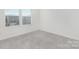 Bedroom featuring soft carpeting, a window with blinds, and bright, neutral decor at 4060 Beacon Ave # 148, Monroe, NC 28110