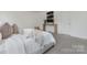 Inviting bedroom features a cozy bed, console table, and modern artwork at 4060 Beacon Ave # 148, Monroe, NC 28110