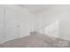 Bright bedroom with two entryways and neutral carpet creating a clean and inviting space at 4060 Beacon Ave # 148, Monroe, NC 28110