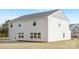 View of two-story home with white siding and large windows overlooking the backyard at 4060 Beacon Ave # 148, Monroe, NC 28110