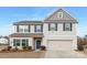Two-story home with blue shutters, a blue door, and a two-car garage at 4060 Beacon Ave # 148, Monroe, NC 28110