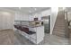 Modern white kitchen featuring an island with bar seating and stainless steel appliances at 4060 Beacon Ave # 148, Monroe, NC 28110