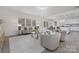 Bright living room with neutral furniture, lots of natural light, and open to dining area at 4060 Beacon Ave # 148, Monroe, NC 28110