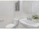 Clean powder room featuring a pedestal sink, toilet, and modern decor at 4060 Beacon Ave # 148, Monroe, NC 28110