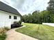 Well-manicured backyard with lush green grass, a stone walkway, and mature trees at 4282 Brandy Creek Ct, Clover, SC 29710