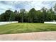 Well-maintained backyard with lush grass, bordered by a white fence and mature trees at 4282 Brandy Creek Ct, Clover, SC 29710