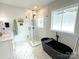 Bathroom featuring a soaking tub, a tiled walk-in shower, and a window that provides natural light at 4282 Brandy Creek Ct, Clover, SC 29710