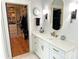 Bathroom with walk-in closet, oval mirror, and white vanity with gold fixtures at 4282 Brandy Creek Ct, Clover, SC 29710