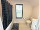 Well-lit bathroom with a bathtub, modern toilet, and a stylish shower curtain at 4282 Brandy Creek Ct, Clover, SC 29710