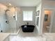 Modern bathroom features a stand-alone soaking tub and a tiled walk-in shower at 4282 Brandy Creek Ct, Clover, SC 29710