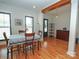 Dining room features wood floors, black-framed windows, and open access to the kitchen at 4282 Brandy Creek Ct, Clover, SC 29710