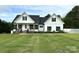 Charming two-story modern farmhouse with black shutters, covered porch, and a well-manicured lawn at 4282 Brandy Creek Ct, Clover, SC 29710
