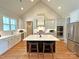 Bright kitchen features stainless appliances, large island, and hardwood floors at 4282 Brandy Creek Ct, Clover, SC 29710