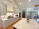 Bright, modern kitchen with white cabinets, stainless steel appliances, and large center island at 4282 Brandy Creek Ct, Clover, SC 29710