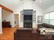 Bright living room with hardwood floors, fireplace, TV, and comfortable leather furniture at 4282 Brandy Creek Ct, Clover, SC 29710