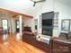 Open-concept living room featuring hardwood floors, fireplace, and comfortable leather seating at 4282 Brandy Creek Ct, Clover, SC 29710