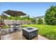 Lawn with patio, firepit, and umbrella covered table in a fenced backyard at 5056 Crandon Rd, Fort Mill, SC 29707