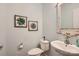 Cozy powder room showcases a pedestal sink, framed artwork, and a classic toilet at 5056 Crandon Rd, Fort Mill, SC 29707