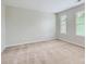 Empty carpeted bedroom features two windows and neutral walls, ready for customization at 5056 Crandon Rd, Fort Mill, SC 29707