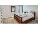 Comfortable bedroom showcasing soft carpet, wooden bed frame, and natural light from a window at 5056 Crandon Rd, Fort Mill, SC 29707